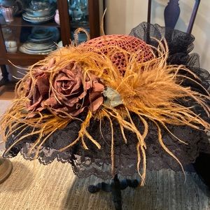 Whimsical Elsie Massey black and brown hat with long tulle black train.